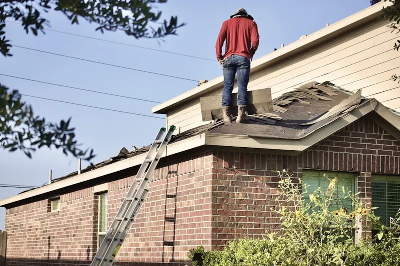Professional roofer working on a residential roof in Padgett Island